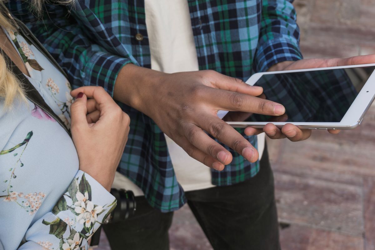 boy pointing smartphone screen